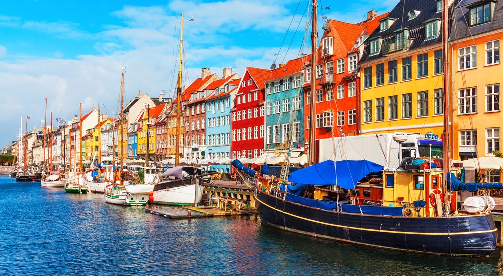 Nyhavn pier with color buildings, ships, yachts and other boats in the Old Town of Copenhagen, Denmark